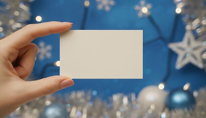 woman hand holding business card infront of navy christmas background