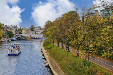 Autumn river cruise boat heading towards Lendle Bridge, York,Yorkshire, UK.