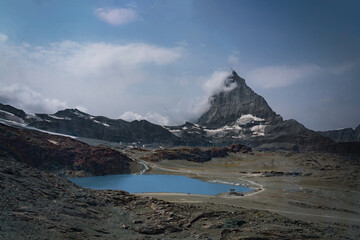 Matterhorn seen from the Glacial Paradise cable car in Zermatt, with the Swiss Alps stretching into the background under a clear alpine sky.