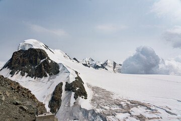 Snow-covered Mt. Breithorn on border of Italy and Switzerland on a clear alpine day, showcasing dramatic peaks, glaciers and panoramic views of the Swiss Alps