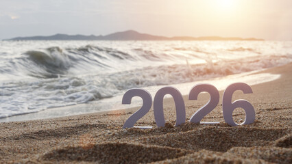 number 2026 for new year sign on summer beach at sunset, with ripple sea wave and beautiful nature at background, 2026 New Year celebration concept