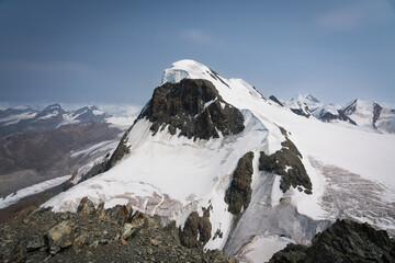 Snow-covered Mt. Breithorn on border of Italy and Switzerland on a clear alpine day, showcasing dramatic peaks, glaciers and panoramic views of the Swiss Alps