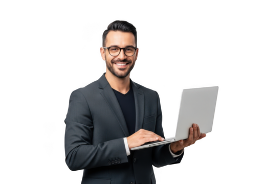 Smiling businessman in a suit and glasses confidently holds and types on a modern laptop against a stark black background