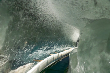 Ice tunnel inside the Matterhorn Glacier Paradise, Zermatt, showcasing deep blue glacial ice and shimmering alpine interiors.