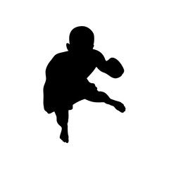 Silhouette of a young boy running with a football ready to pass