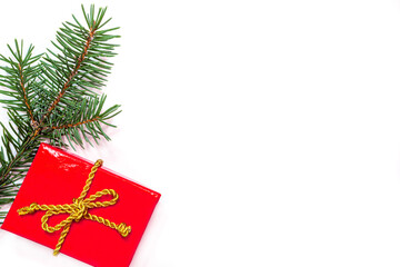 Christmas background - red gift box with golden cord and fir branches
