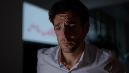 Stressed businessman working late, feeling overwhelmed in a dimly lit office, reflecting work-life balance challenges, ideal for Stress Awareness Day