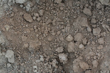 Top view of soil with clumps, natural earth texture.