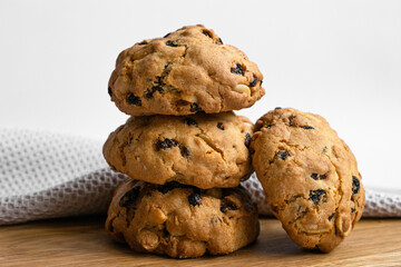 Peanut  randaisin cookies on wooden table. Close up photo pile cookies on light background. For article, blog and recipe.	
