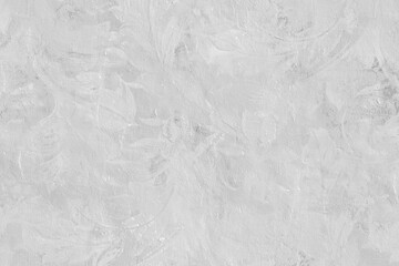 grey plaster wall with subtle textured brush strokes creating a minimal abstract background.
