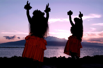 Maui, Hawaii, United States. Traditional hula dancers at the beach at sunset