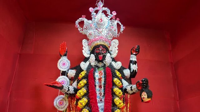 Beautiful Kali Maa idol with red background in Kolkata