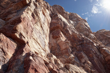 Majestic rock formation with sunlit peaks and clear blue sky