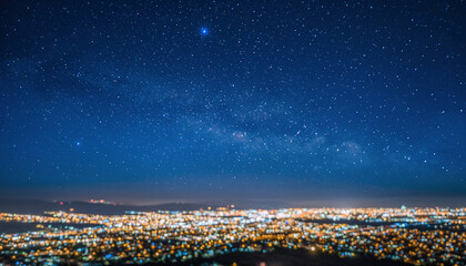 City lights glow under a vast starry night sky.