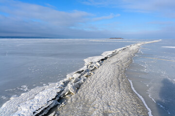 Vast Frozen Lake with a Pressure Ridge Under a Blue Sky