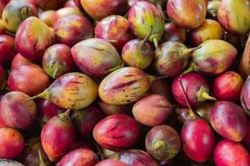 Red Ripe Tamarillo (Tree Tomato) Fruits at a Kenyan Market Stall
Ripe red tamarillos, also known as tree tomatoes, displayed at a Kenyan market stall, highlighting tropical fruit and healthy eating