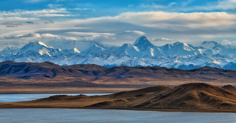 Northern Tien Shan mountain range with Khan Tengri peak in southeast Kazakhstan under a cloudy sky	