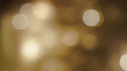 Soft shimmering golden shapes create a warm atmospheric Christmas light scene.