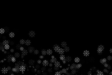 Many falling snowflakes on black background