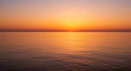 Obraz premium Brilliant golden sunlight touches the calm horizon above expansive tranquil water