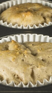 Banana nut muffins cooking close up time lapse.  Vertical video.