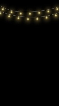 Twinkling fairy lights glow in soft amber. Golden garland loops around festive corner. Warm bulbs dangle on celebration wire. flicker looping light animation background. 4k