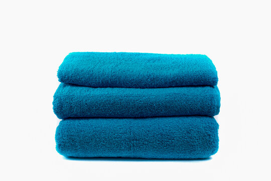 Blue terry towel folded isolated on white background