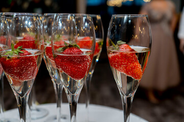 Glasses full of champagne and strawberries