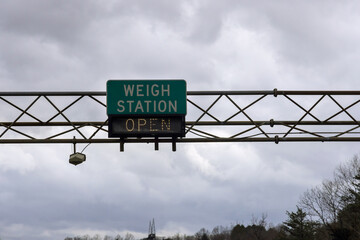 Weigh station sign shows it is open, located on American highway