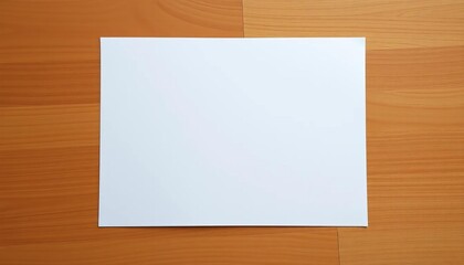 A single sheet of blank white printer paper lies flat on a textured wooden surface,  supplies,  flatlay