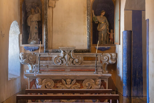 Altar in the left aisle of the church Santa Croce with the statues of the Archangels Gabriel and Raphael, Gravina in Puglia, Italy