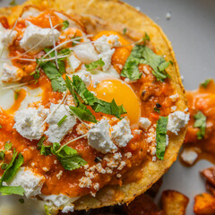 huevos rancheros with roasted potatoes on plate