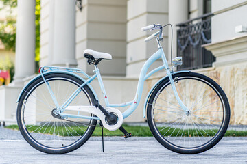 Side view of a modern city urban city bike or bicycle for street road. City bicycle parked on a lawn. Urban bike standing upright on grass, static, no people.