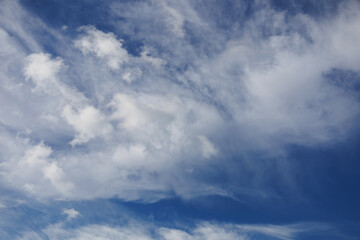 Soft bright blue sky with white few clouds. Calm texture. Nature abstract background. Fresh air, weather and freedom concept. Clear sky in the morning. The cloud float and clump like cotton.