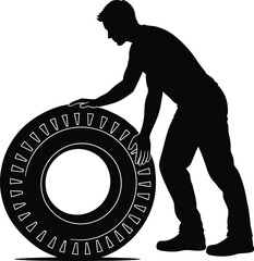 Silhouette of Man Rolling Large Tire for Mechanical or Industrial Work