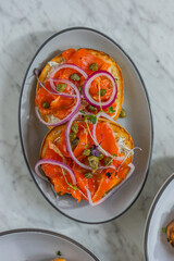 smoked salmon bagel with capers and red onion