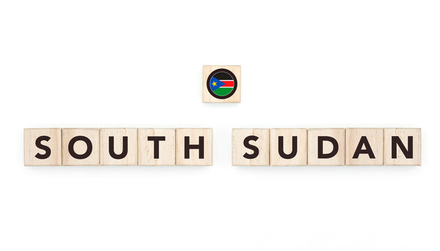 Wooden blocks bearing the name and flag of South Sudan. South Sudanese and African Culture, national identity, travel, and geography in a copy space design.