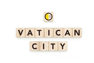 Wooden blocks bearing the name and flag of Vatican City. Vatican and European Culture, national identity, travel, and geography in a copy space design.
