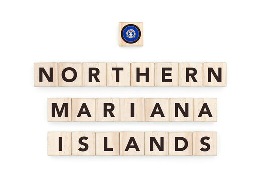 Wooden blocks bearing the name and flag of Northern Mariana Islands. Marianan and Polynesian Culture, national identity, travel, and geography in a copy space design.