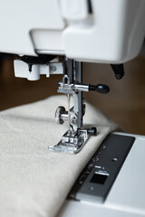 a close-up of a sewing machine presser foot resting on fabric