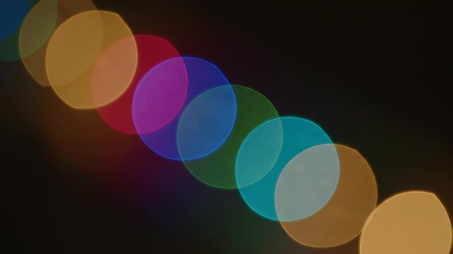 Colorful Bokeh: A mesmerizing display of colorful bokeh lights, arranged in a diagonal pattern against a dark backdrop, creating a visually stunning effect. 
