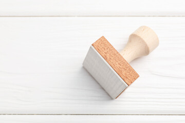 One wooden stamp on white table, top view. Space for text