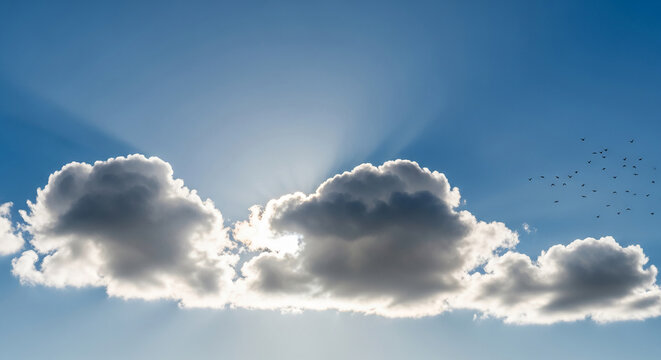 Bright blue sky with a large cloud and sun rays shining through, representing hope, freedom, and natural beauty, ideal for serene themes