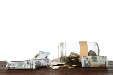 Jar with blank note and money on wooden table against white background