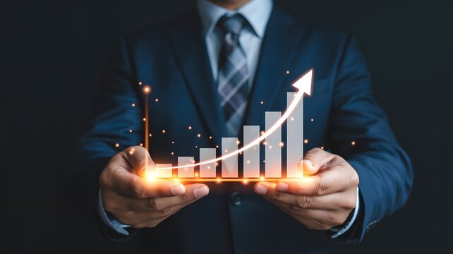 Businessman holding a glowing orange bar graph with rising arrow, symbolizing financial growth, business success, performance improvement, data analytics, and futuristic economic progress