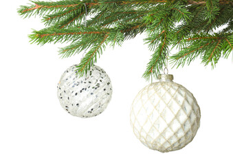 Christmas balls hanging on fir tree branches isolated on white