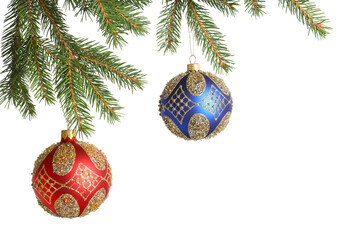 Christmas balls with pattern hanging on fir tree branches isolated on white. Space for text