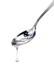 A shiny silver spoon with a dripping liquid