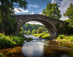 Fototapeta premium Picturesque view of stone bridge over the river in natural rural landscape