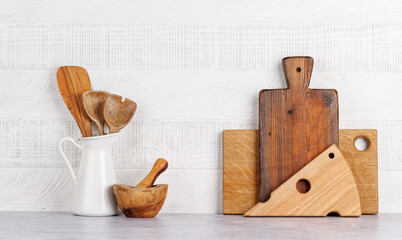 Kitchen utensils and cutting boards on table